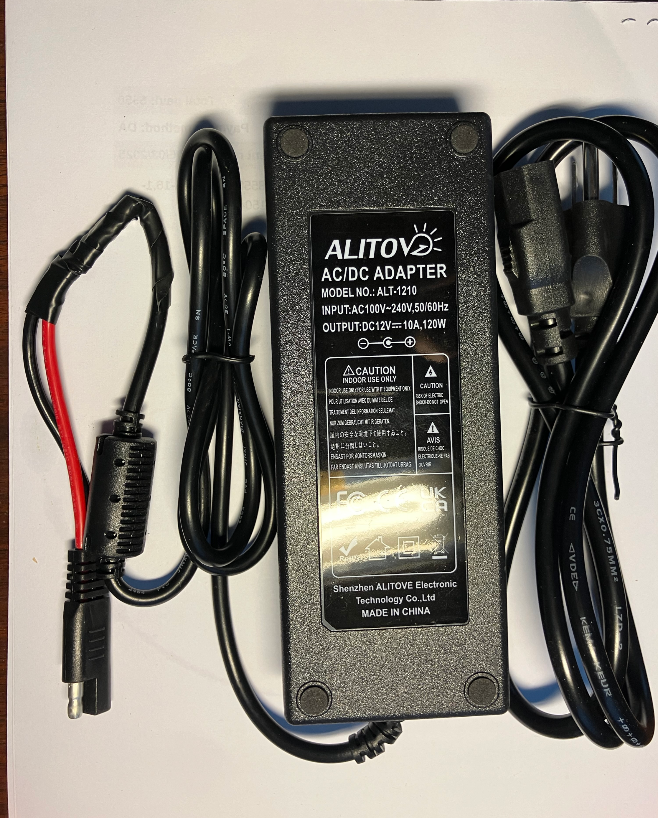 Black AC-to-12V DC converter brick (10A) with DC output leads for powering the Snorkel 12V Drywasher from a generator or wall outlet.